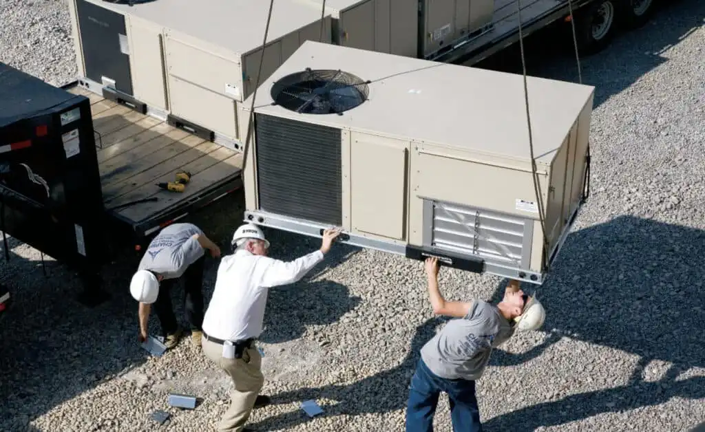 HVAC technicians installing commercial air conditioning unit in Los Angeles.