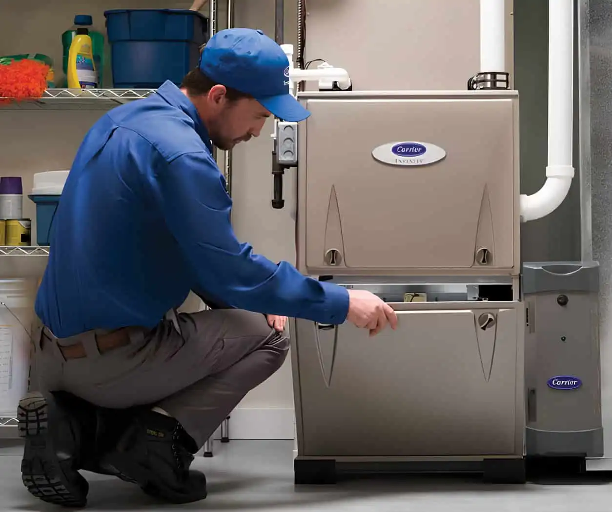 Carrier HVAC system being serviced in a garage setting.