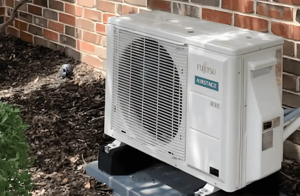 Fujitsu air source heat pump outside near house wall in Los Angeles.