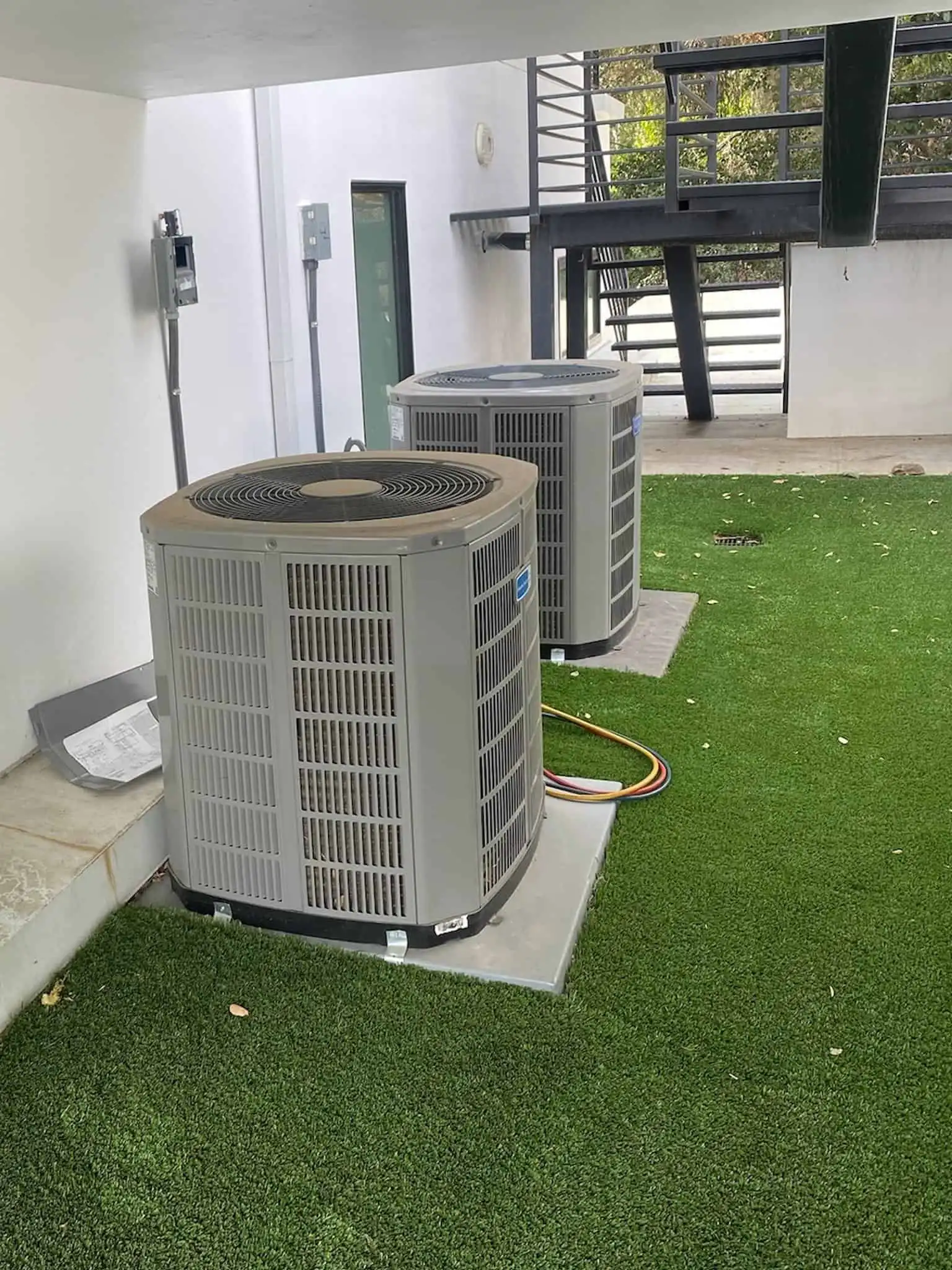 High-efficiency outdoor HVAC units on a grassy area in Los Angeles.