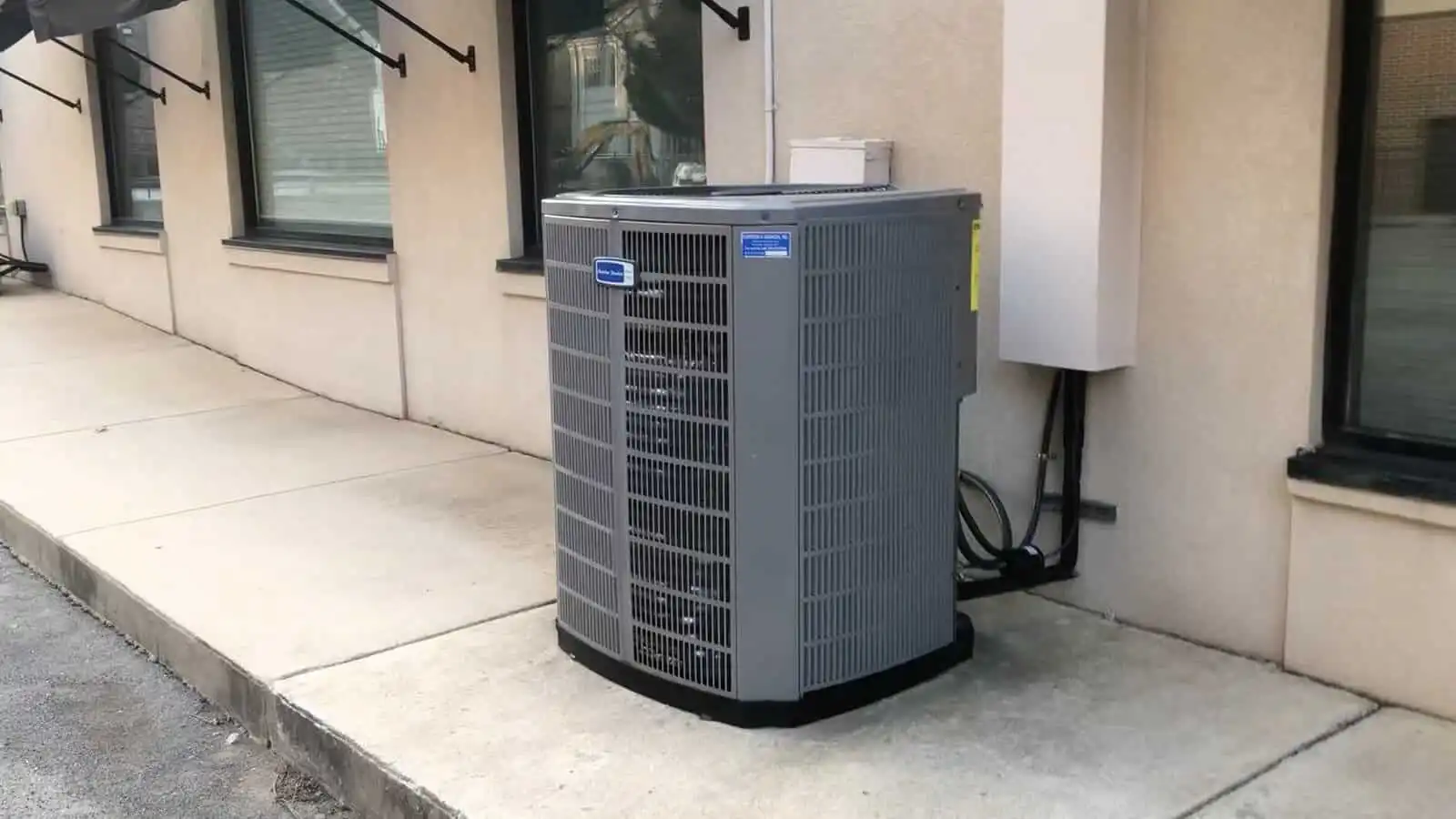 High-efficiency HVAC air conditioning unit outside a residential building in Ventura County.