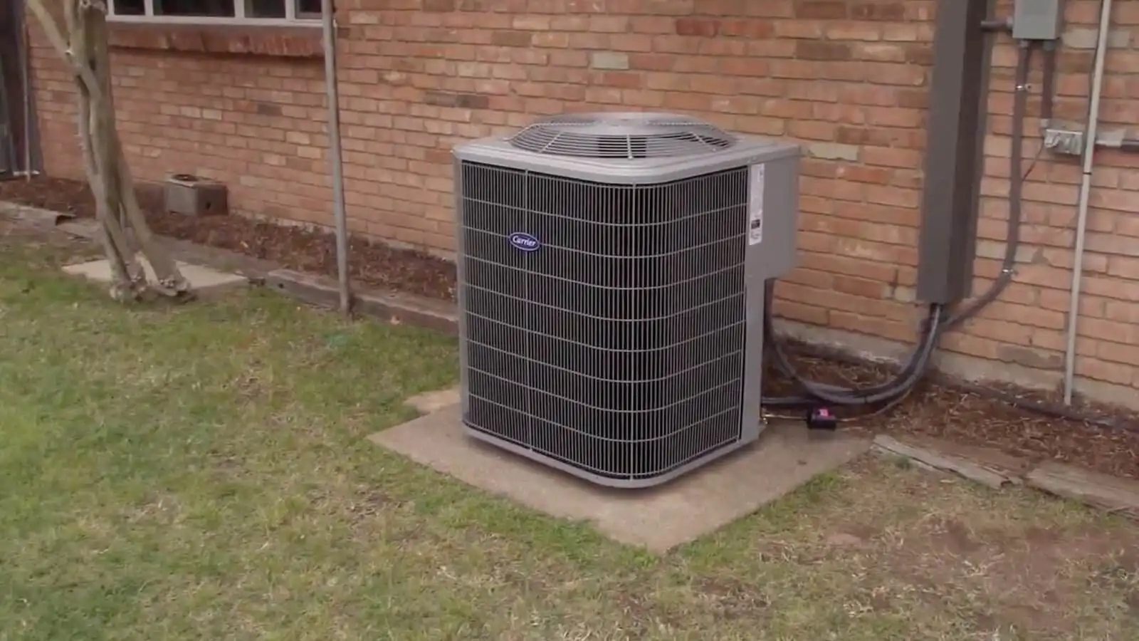 Outdoor air conditioning unit on concrete pad.