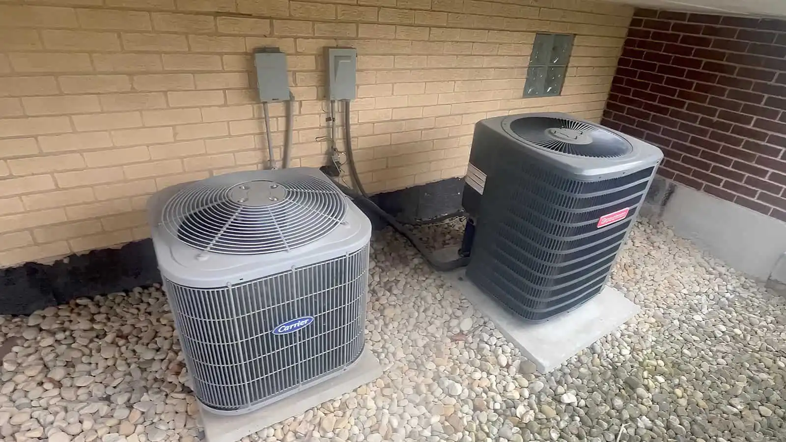 Two outdoor air conditioning units installed outside a building in Los Angeles.