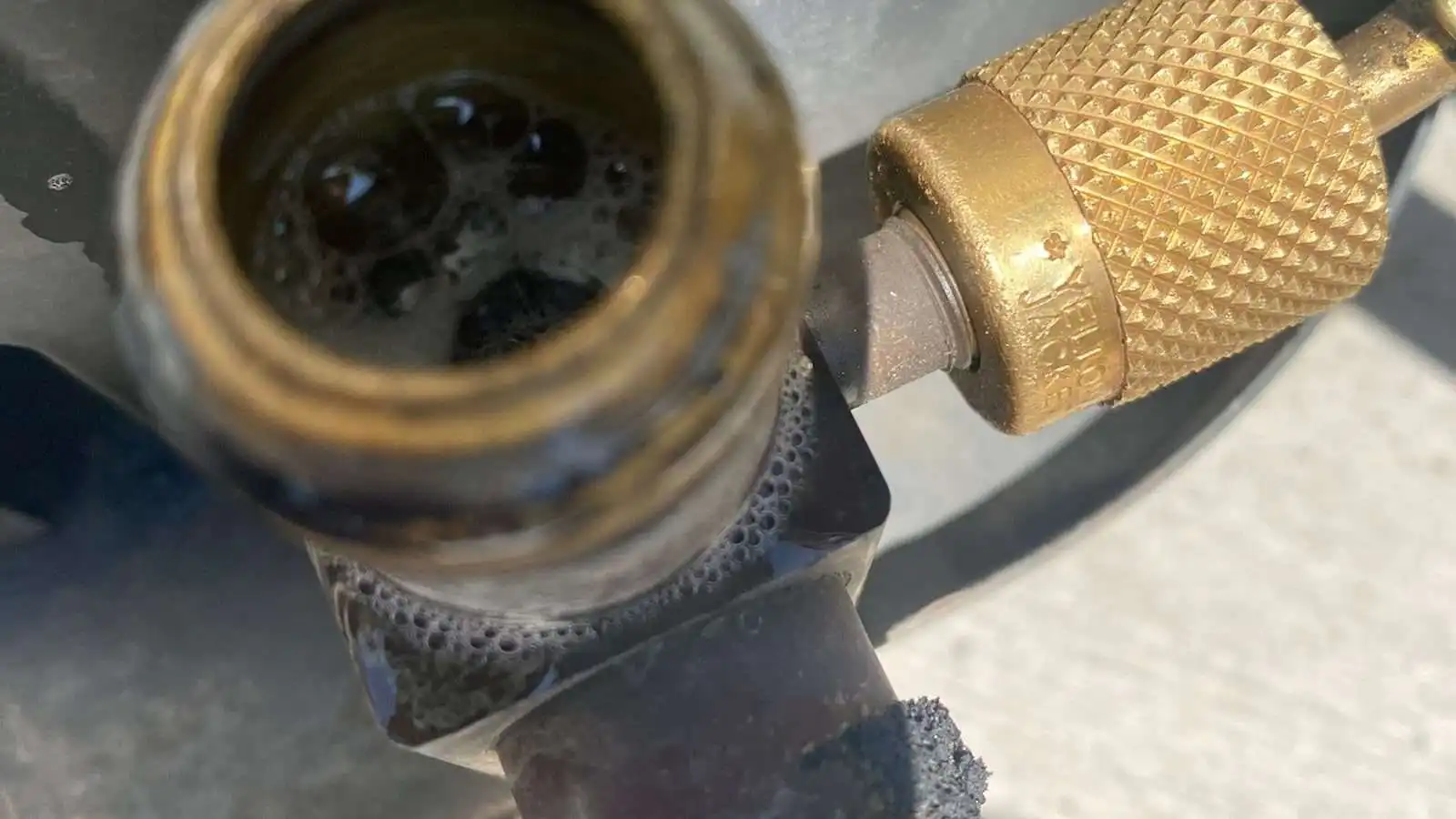 Corroded refrigerant fitting found during an AC leak check