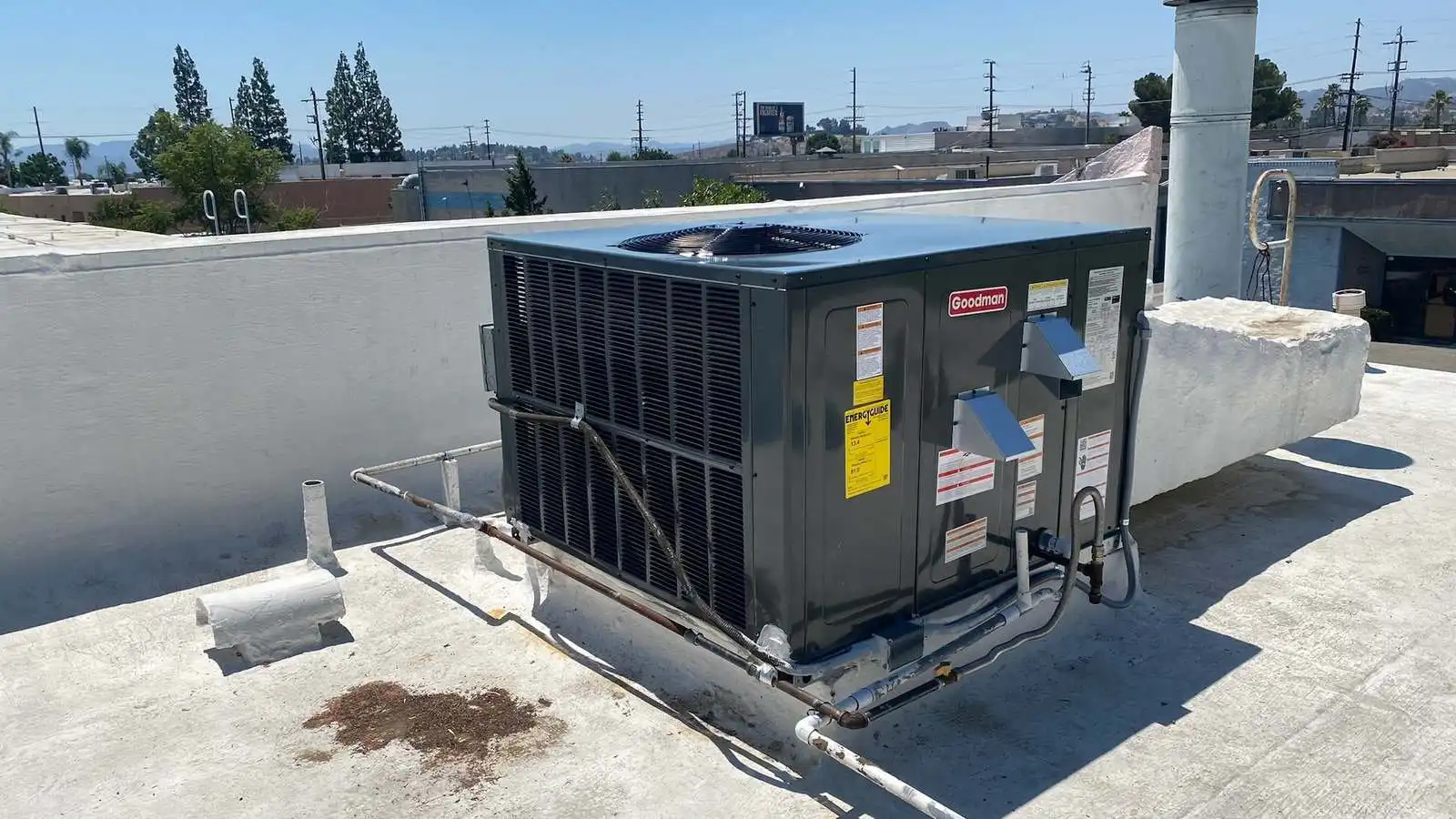 A cleanly installed rooftop AC unit running after service