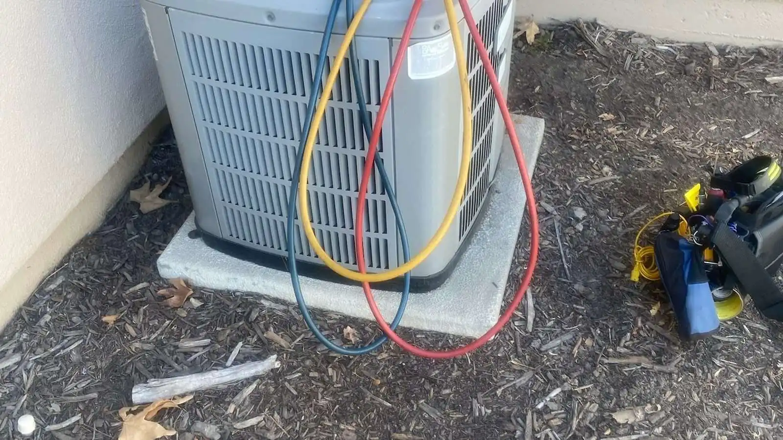 Manifold gauges connected to an AC condenser to check pressures before a repair is priced