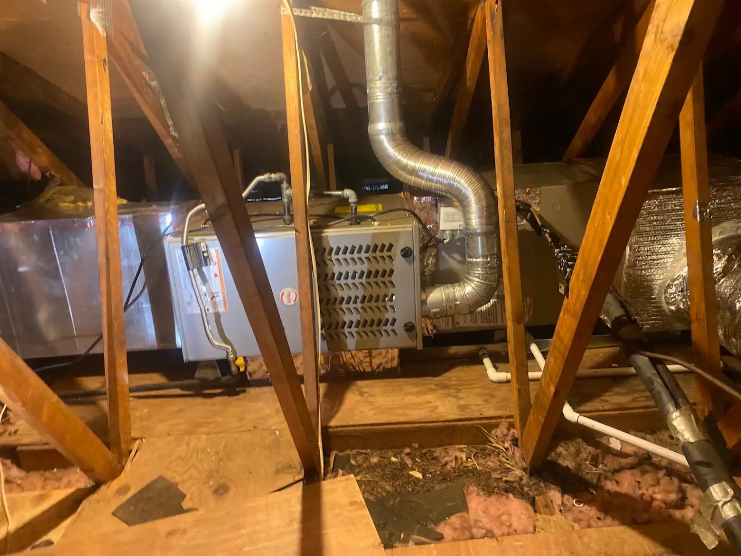 Horizontal furnace and air handler installed in a residential attic, where condensate drain problems begin