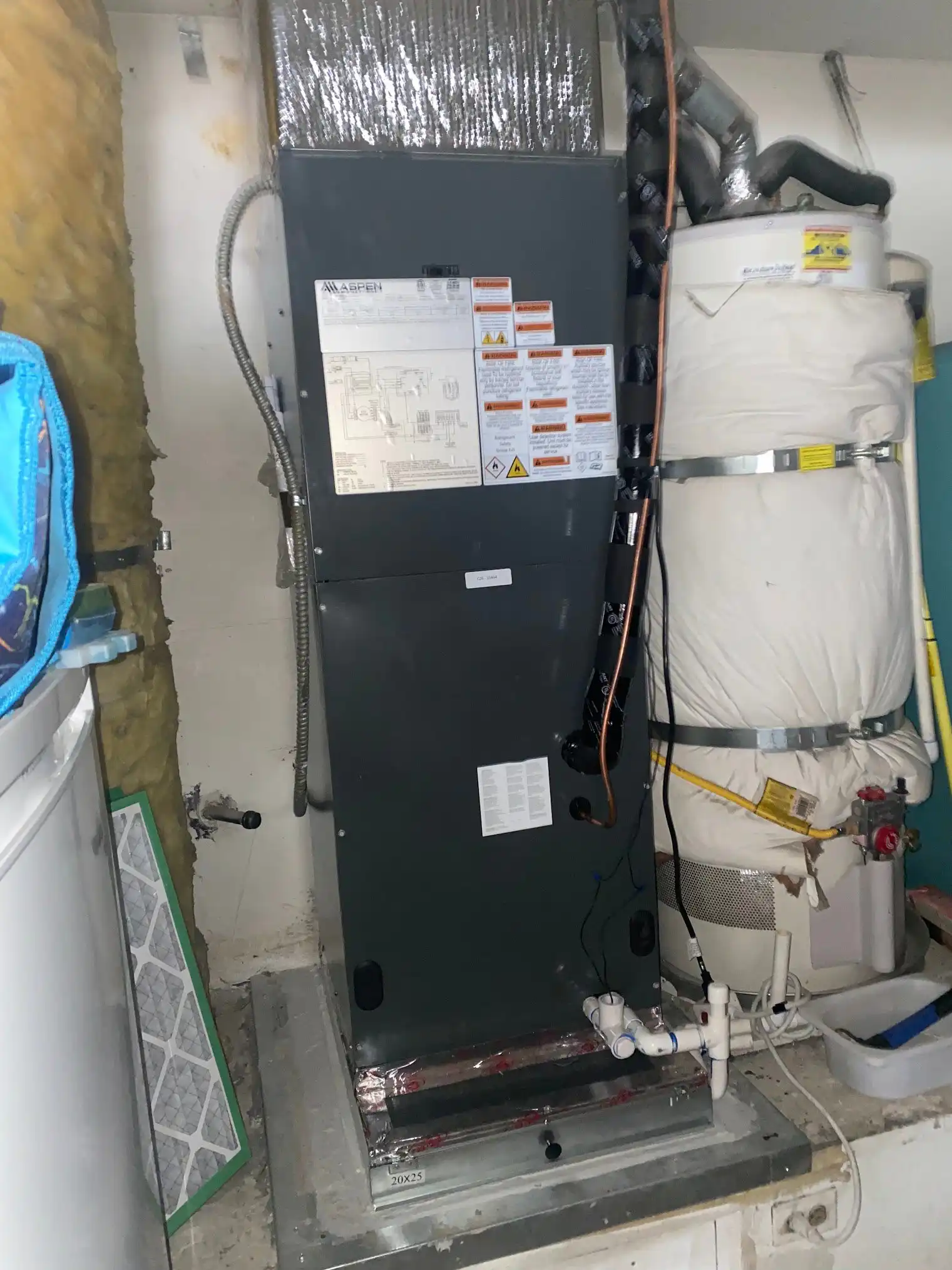 Upright air handler with its condensate line, where drain clogs and overflow shutoffs start