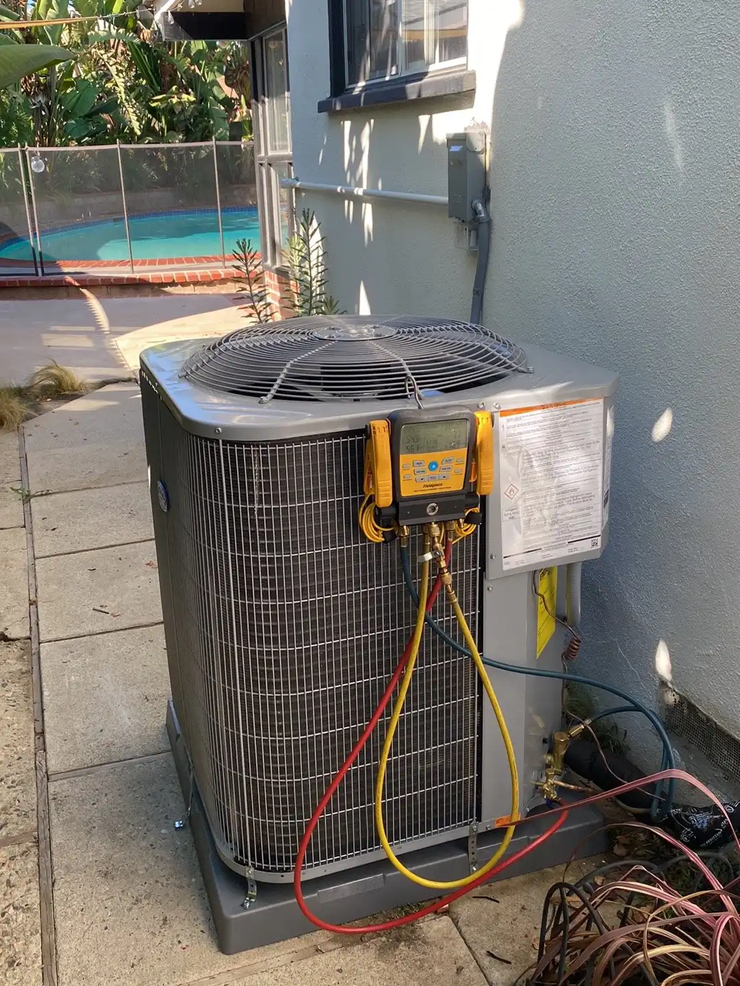Digital manifold gauges on an AC condenser, used to check pressures before we price a repair