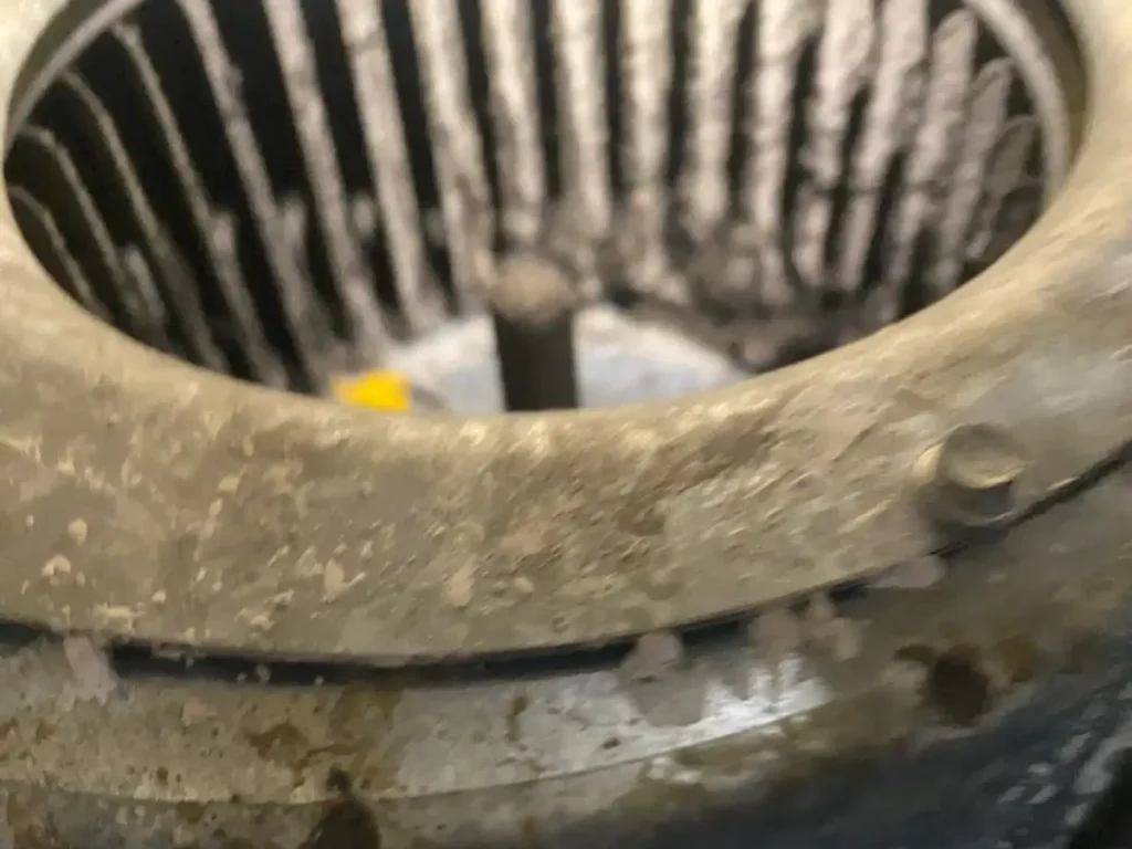 Blower wheel with heavy dust buildup on its blades
